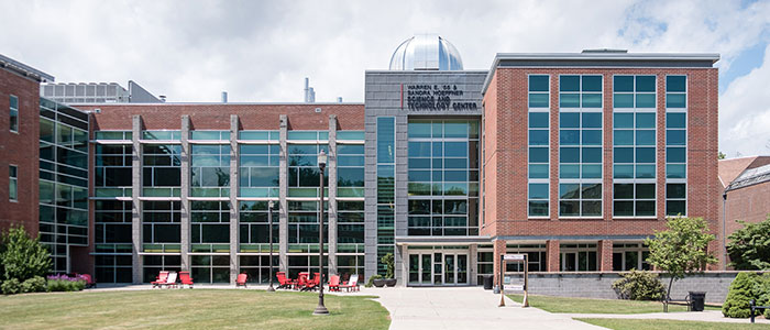 A photo of East Stroudsburg University's Science and Technology Center. The building is mostly brick, with many large, blue windows.